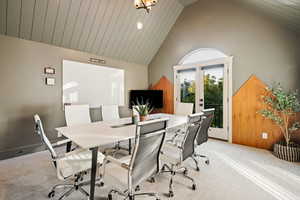 Office area featuring french doors, carpet, and high vaulted ceiling