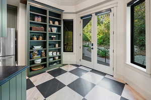 Entryway featuring healthy amount of natural light, french doors, and tile patterned floors
