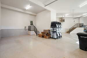 Garage with a wainscoted wall and a heating unit