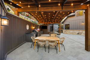 View of patio with outdoor dining area and an outdoor kitchen