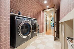 Laundry room featuring wallpapered walls, recessed lighting, and washing machine and clothes dryer
