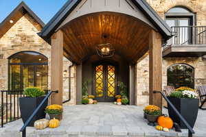 Entrance to property with french doors and stone siding