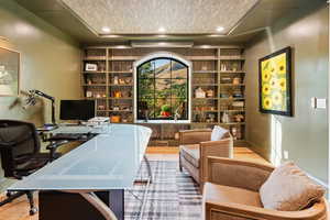 Office featuring built in features, recessed lighting, light wood-style flooring, and a textured ceiling
