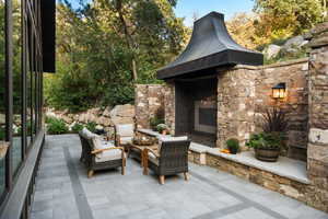View of patio with an outdoor living space with a fireplace