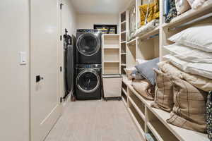 Laundry room with stacked washer and clothes dryer