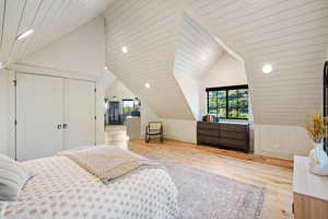 Bedroom with recessed lighting, lofted ceiling, light wood-style flooring, and a closet