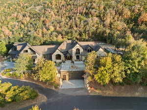 Aerial view of property and surrounding area featuring a heavily wooded area