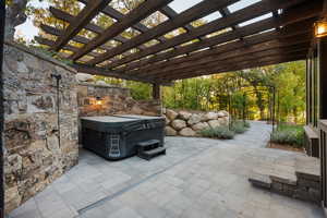 View of patio / terrace with a pergola and a hot tub