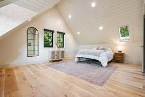 Bedroom featuring lofted ceiling, wood finished floors, and recessed lighting