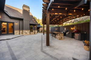 View of patio featuring an outdoor kitchen and french doors