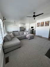 Living area with a textured ceiling and ceiling fan