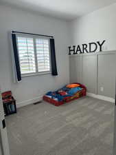 Bedroom with carpet flooring and baseboards