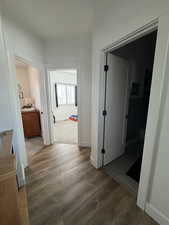 Hallway with wood finished floors and baseboards