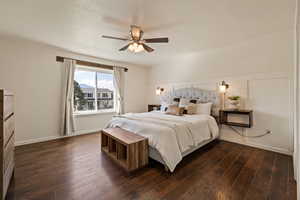 Bedroom with ceiling fan and dark wood-style flooring