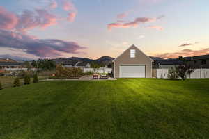 Fenced backyard with a mountain view, a patio, and a garage