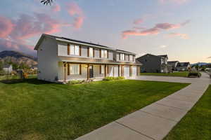 View of front of property featuring concrete driveway, a porch, a mountain view, a garage, and solar panels