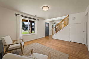 Living area featuring stairway and light wood-type flooring