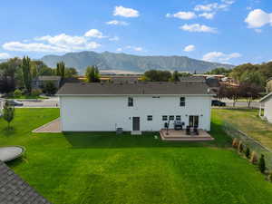 Rear view of house with a deck with mountain view