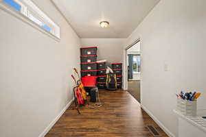 Hallway with baseboards and dark wood-style floors