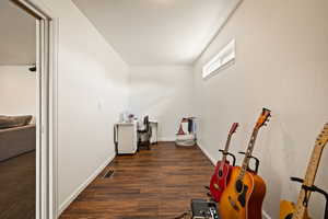 Bathroom featuring baseboards and dark wood finished floors