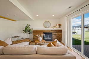 Living room featuring a fireplace, wood finished floors, and recessed lighting