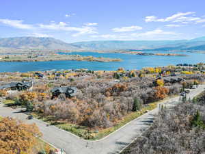 Water view with a mountain backdrop and nearby suburban area