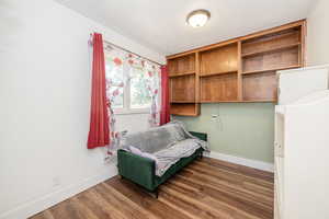 Living area featuring dark wood-style flooring and a textured ceiling