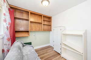 Unfurnished office featuring a textured ceiling and light wood-type flooring