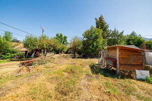 View of yard featuring an outdoor structure and exterior structure