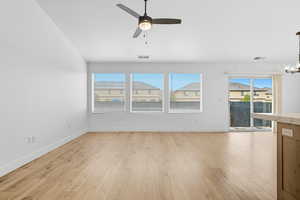 Unfurnished living room with light wood-type flooring and a ceiling fan