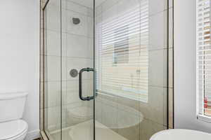 Full bathroom featuring a stall shower and a soaking tub