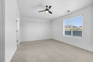 Unfurnished room with light carpet and a ceiling fan
