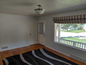 Foyer featuring a textured ceiling and wood finished floors
