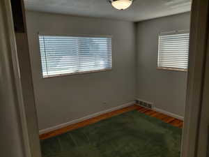 Bedroom 2 with wood finished floors and plenty of natural light