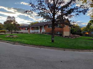 Ranch-style home with a porch and brick siding