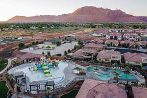 Aerial view of residential area featuring a pool area and mountains