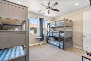 Bedroom featuring light carpet, ceiling fan, and recessed lighting