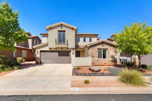 Mediterranean / spanish home featuring stucco siding, concrete driveway, a balcony, stone siding, and an attached garage