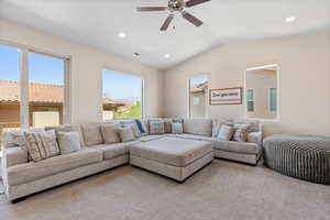 Living area with carpet, lofted ceiling, recessed lighting, and ceiling fan