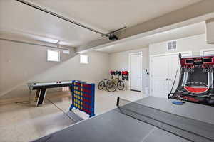 Garage featuring baseboards and a garage door opener