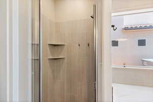 Full bathroom with a stall shower and a bath