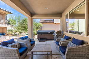 View of patio featuring an outdoor hangout area, a hot tub, and area for grilling