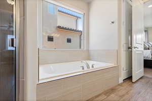 Full bathroom with ensuite bathroom and a bath