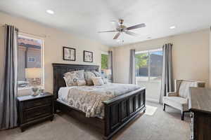 Bedroom with light colored carpet, ceiling fan, and recessed lighting