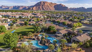 Aerial view of residential area featuring mountains and a pool area