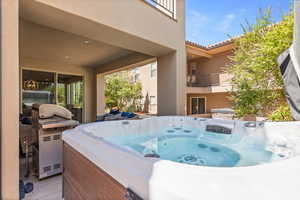 Patio / terrace with a hot tub, area for grilling, and a patio