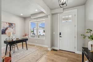 Entryway featuring light wood finished floors and recessed lighting