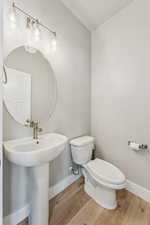 Bathroom featuring wood finished floors and toilet