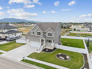 View of front of home featuring driveway, a residential view, roof with shingles, and an attached garage