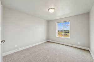 Carpeted empty room with baseboards